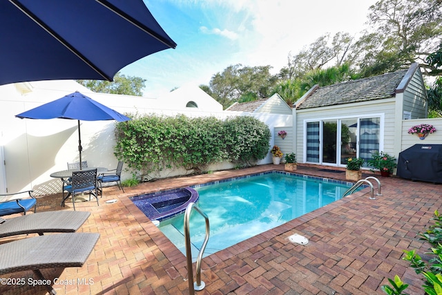 view of pool featuring area for grilling and a patio area