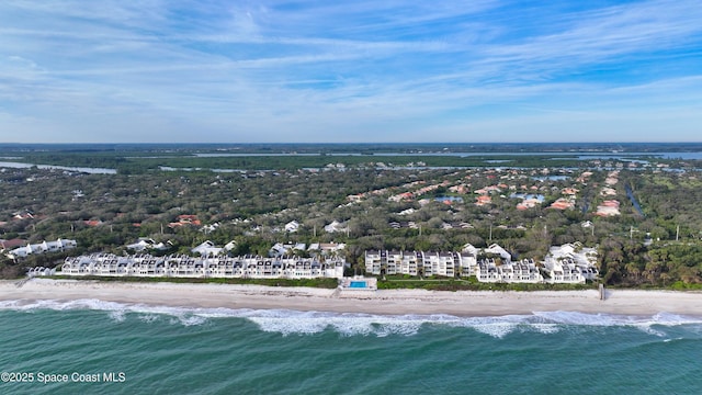 birds eye view of property featuring a water view and a beach view