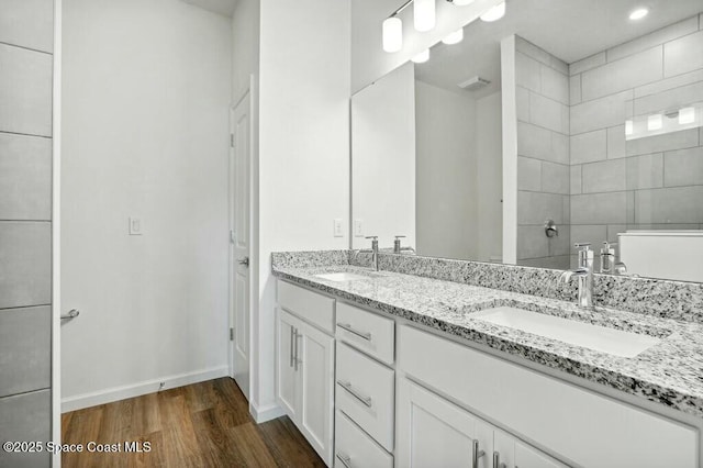 bathroom with vanity, wood-type flooring, and walk in shower