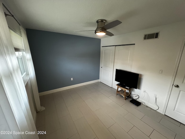 unfurnished living room featuring ceiling fan