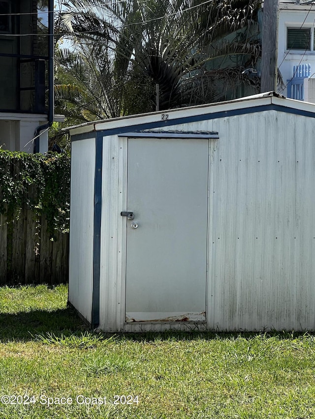 view of outbuilding featuring a lawn