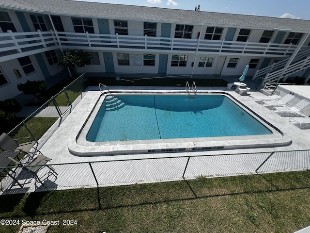 view of pool featuring a yard and a patio area