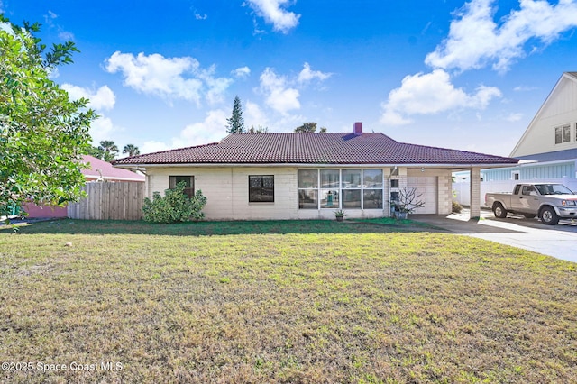 ranch-style home with a garage and a front lawn