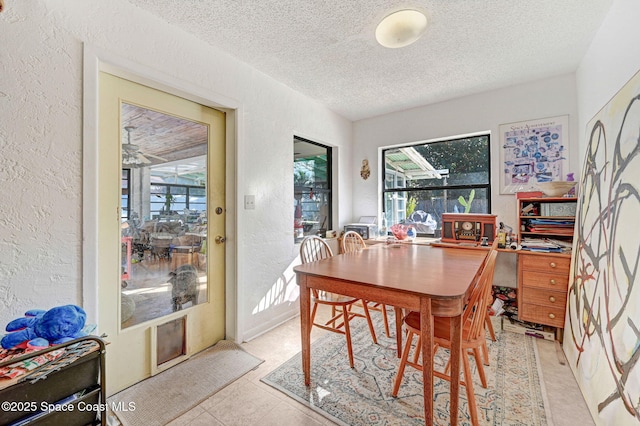 dining room with a healthy amount of sunlight and a textured ceiling