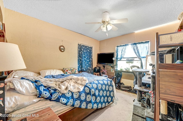 bedroom featuring ceiling fan, carpet flooring, and a textured ceiling