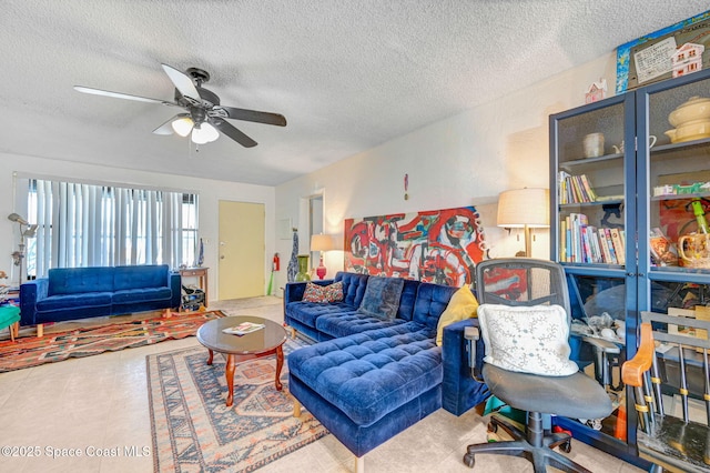 living room with a textured ceiling and ceiling fan