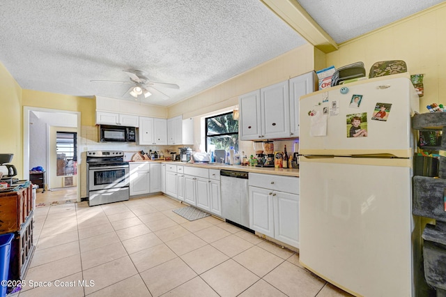 kitchen featuring white cabinetry, appliances with stainless steel finishes, light tile patterned flooring, and ceiling fan