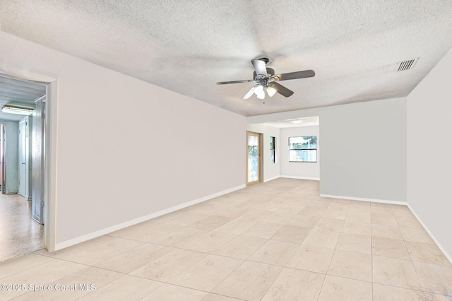 spare room featuring a textured ceiling and ceiling fan