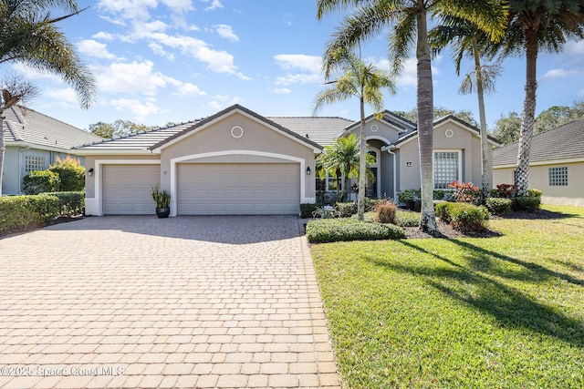 single story home with a garage and a front yard