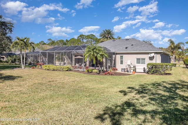 back of property featuring a yard and glass enclosure