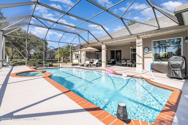 view of pool featuring an in ground hot tub, ceiling fan, glass enclosure, and a patio area