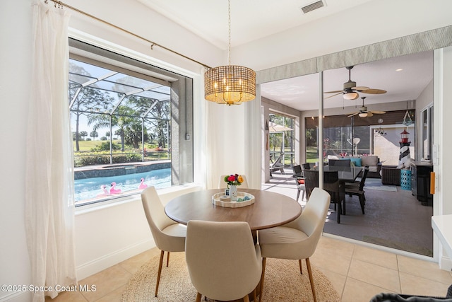 tiled dining space with ceiling fan