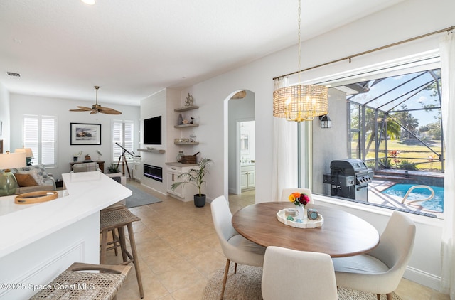 tiled dining area with ceiling fan