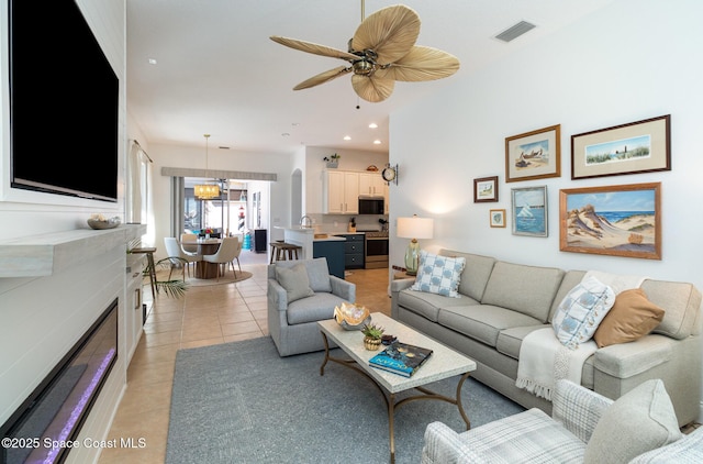 tiled living room with ceiling fan