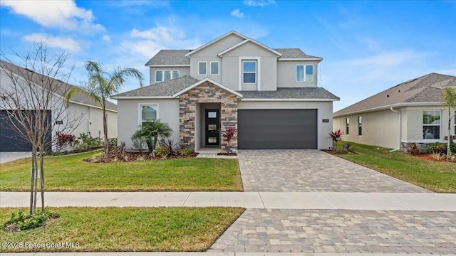 view of front of house with a garage and a front lawn