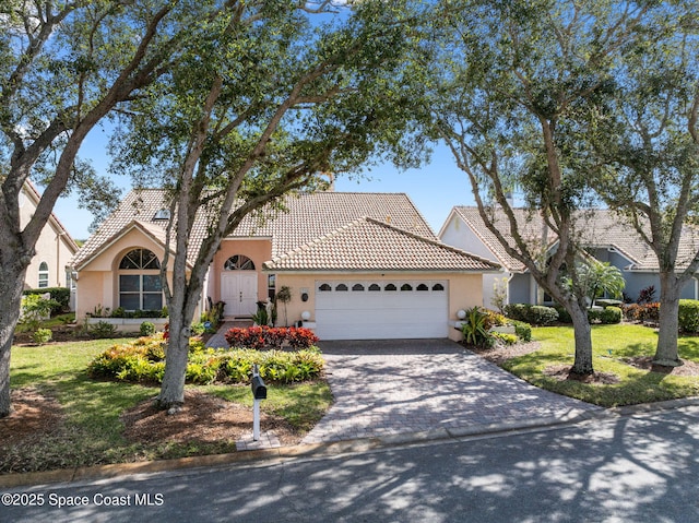 view of front of home featuring a garage and a front lawn