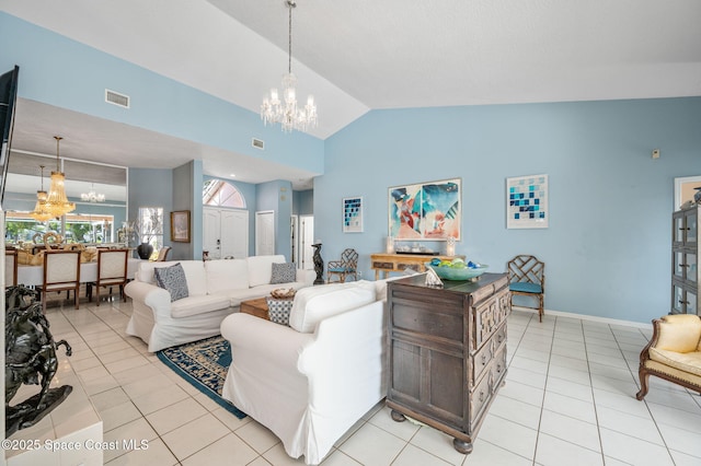 living room featuring light tile patterned floors, vaulted ceiling, and a chandelier