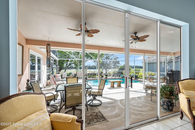 sunroom / solarium with a swimming pool and ceiling fan