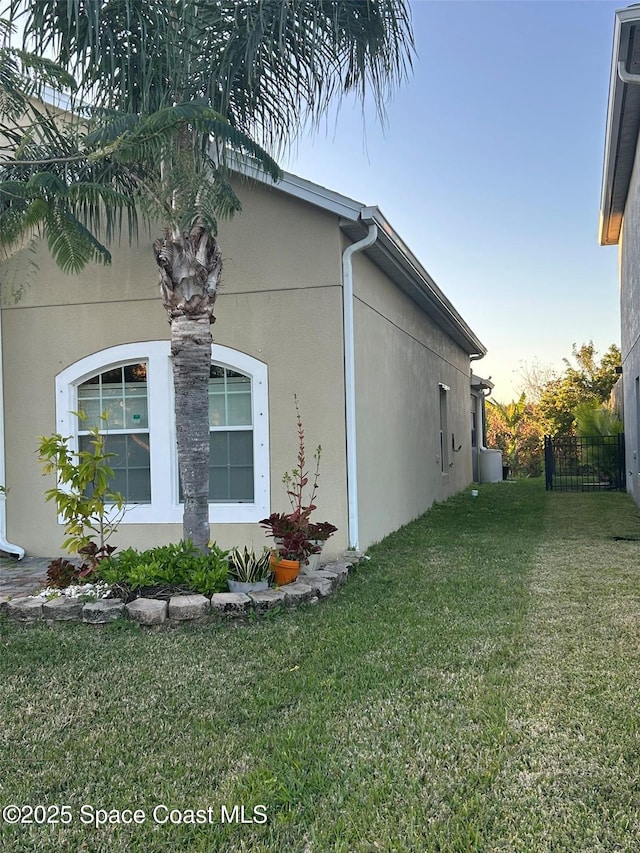 view of side of home featuring a yard