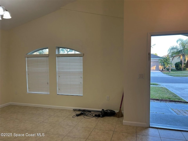 tiled entrance foyer featuring vaulted ceiling and a wealth of natural light