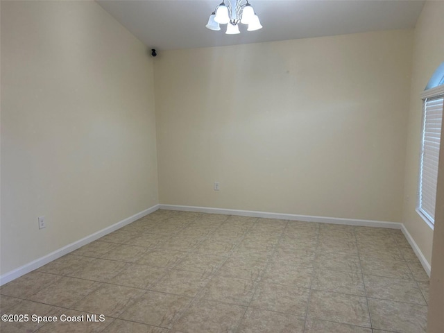 unfurnished room with a chandelier