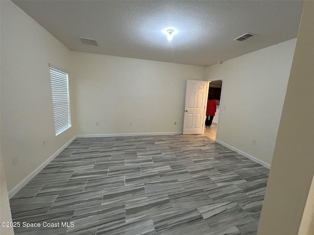 empty room featuring a textured ceiling