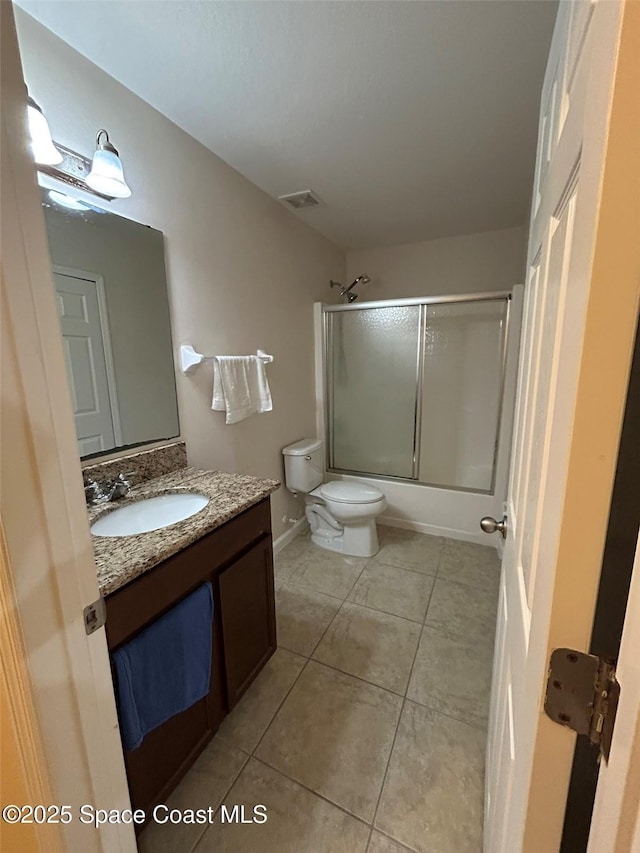 full bathroom with vanity, tile patterned floors, shower / bath combination with glass door, and toilet