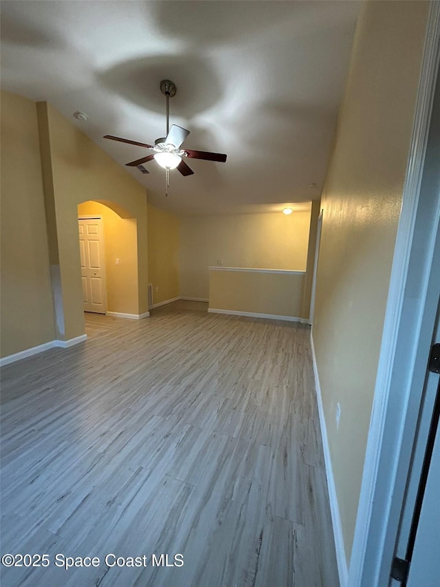 spare room with ceiling fan and light hardwood / wood-style flooring