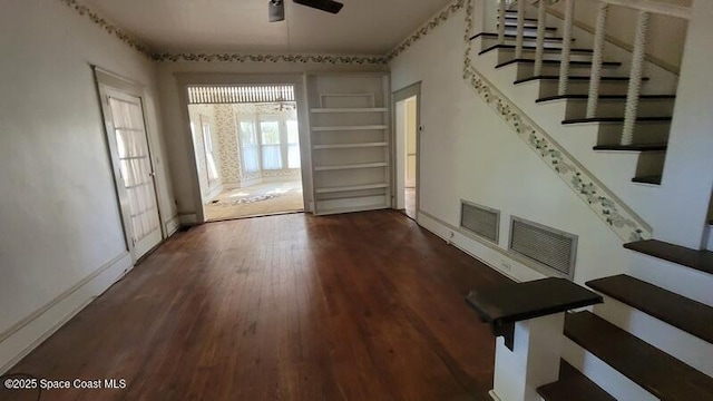 interior space featuring dark wood-type flooring and ceiling fan