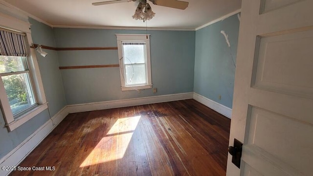 empty room with dark hardwood / wood-style flooring, ornamental molding, and ceiling fan