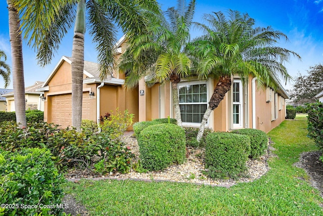 view of front of property featuring a garage and a front yard