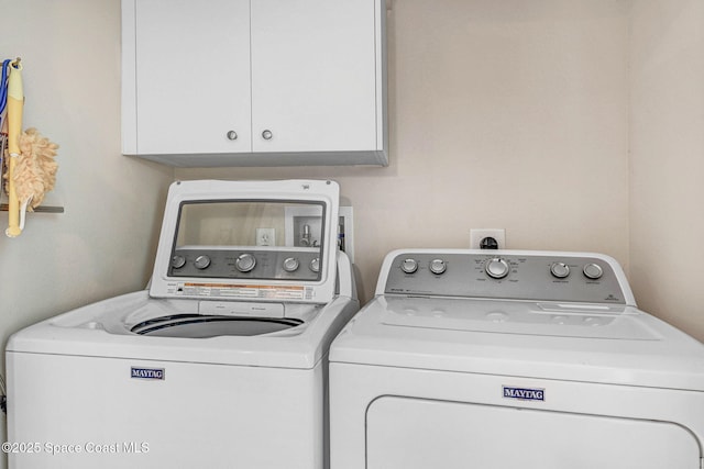 washroom with cabinets and separate washer and dryer