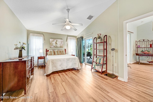 bedroom featuring high vaulted ceiling and light hardwood / wood-style flooring