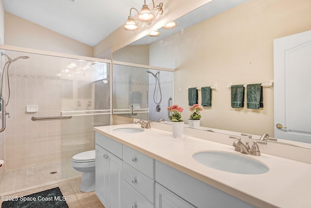 bathroom featuring walk in shower, toilet, vaulted ceiling, vanity, and tile patterned flooring