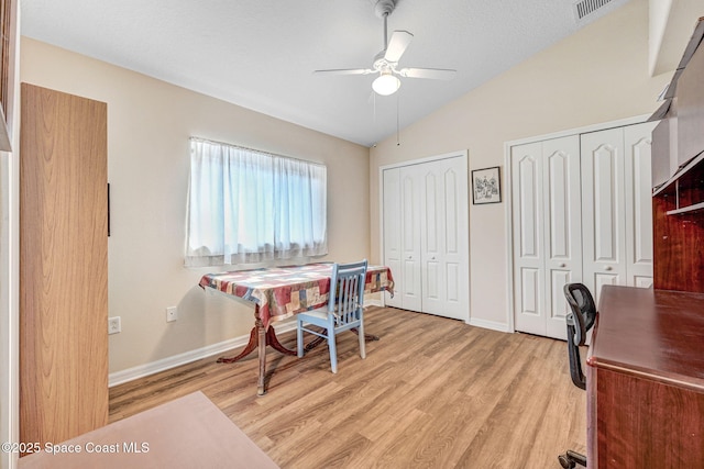 office area featuring vaulted ceiling, ceiling fan, and light hardwood / wood-style floors