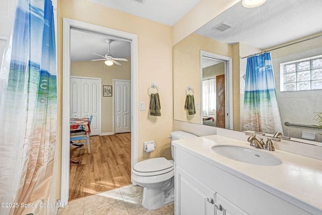 bathroom featuring tile patterned flooring, vanity, a textured ceiling, and toilet