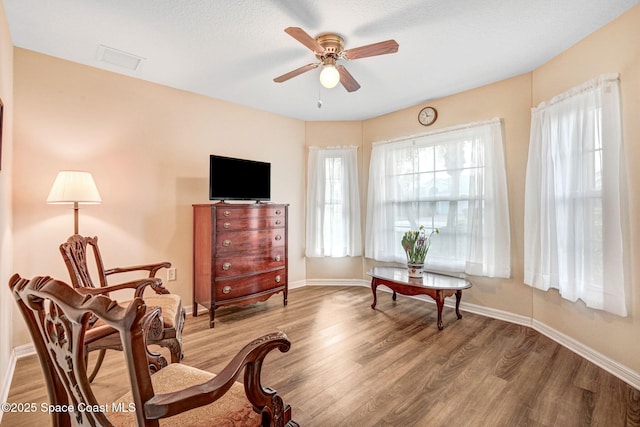 sitting room featuring hardwood / wood-style flooring and ceiling fan