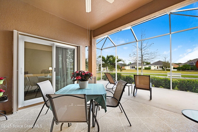 sunroom featuring ceiling fan