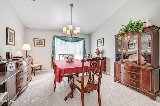 tiled dining area featuring vaulted ceiling, a notable chandelier, and a textured ceiling