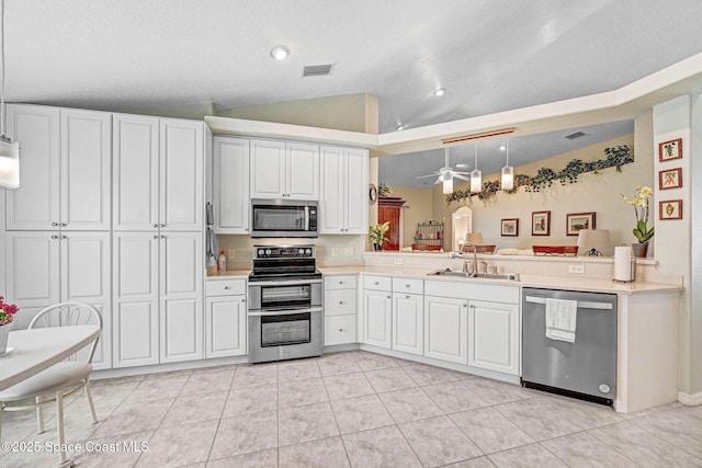 kitchen featuring white cabinetry, appliances with stainless steel finishes, kitchen peninsula, and sink