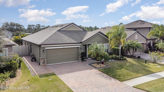 view of front of house featuring a garage and a front yard