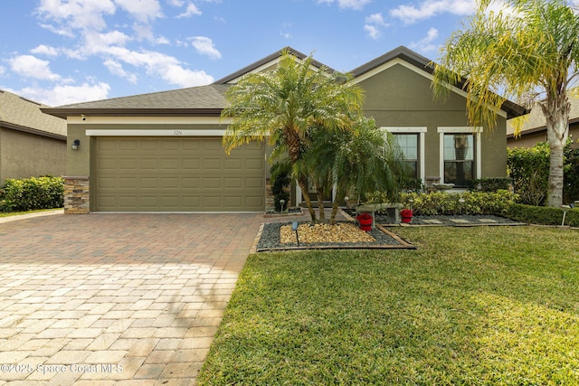 view of front of property with a garage and a front yard