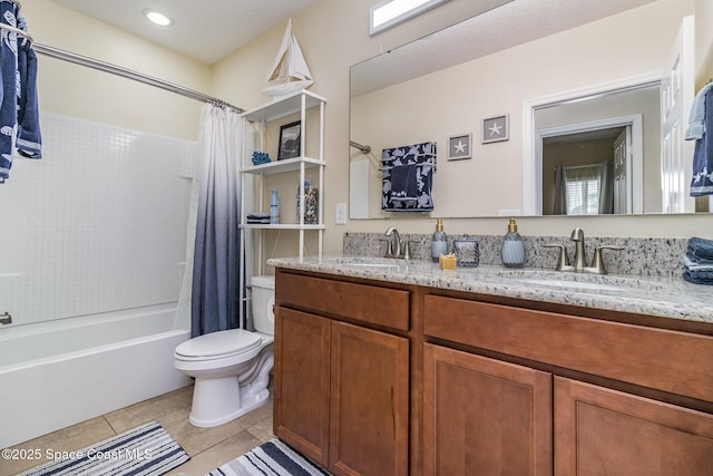 full bathroom with tile patterned flooring, toilet, vanity, and shower / bath combo with shower curtain