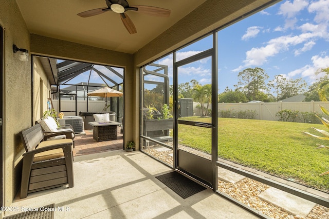 unfurnished sunroom featuring ceiling fan