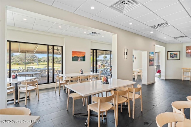 dining space with a drop ceiling