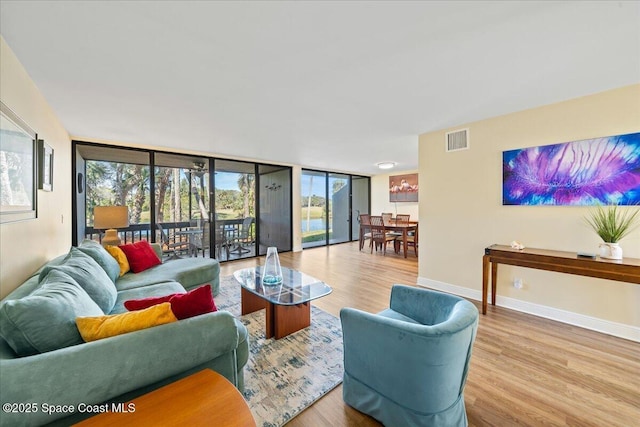 living room featuring light hardwood / wood-style floors and expansive windows