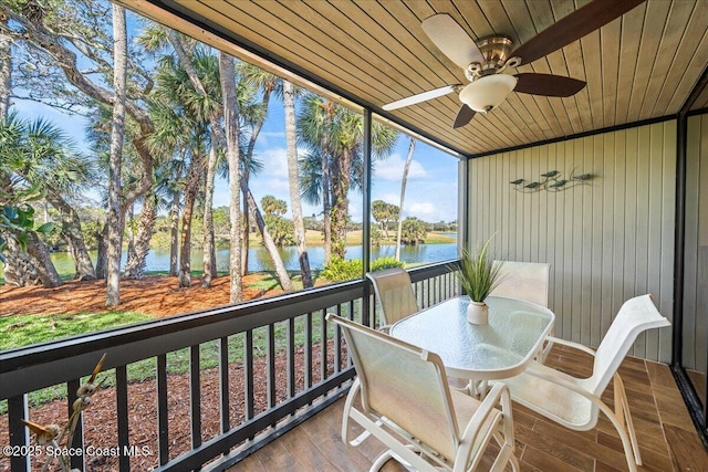 exterior space with a water view and ceiling fan