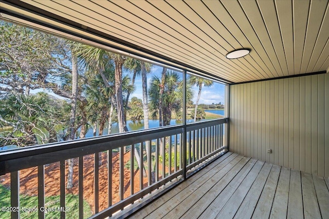 wooden terrace featuring a water view