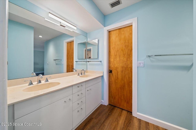 bathroom featuring hardwood / wood-style flooring and vanity