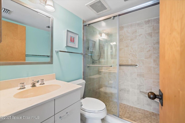 bathroom featuring vanity, toilet, and an enclosed shower